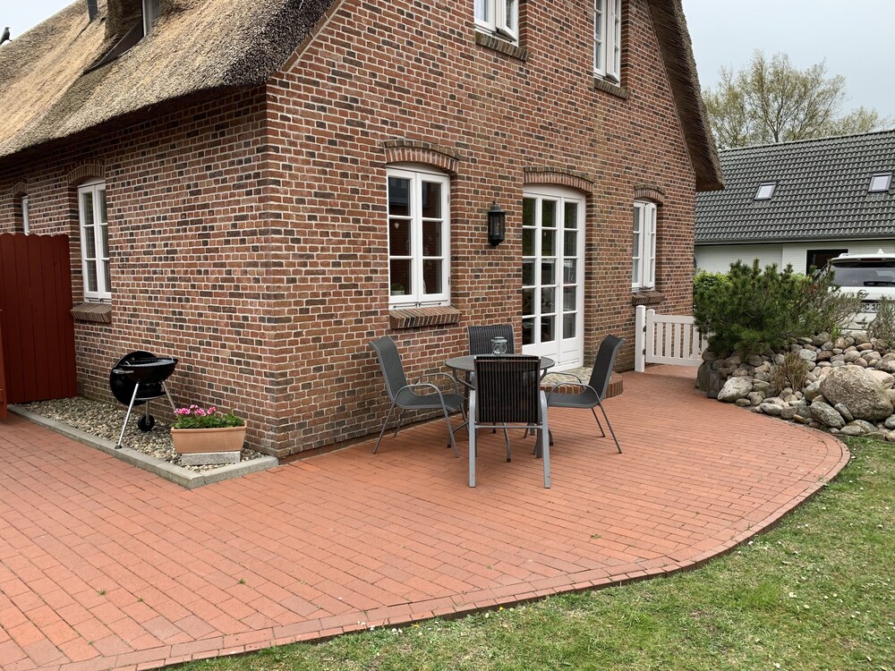 a thatched semi-detached house with parking space for up to 2